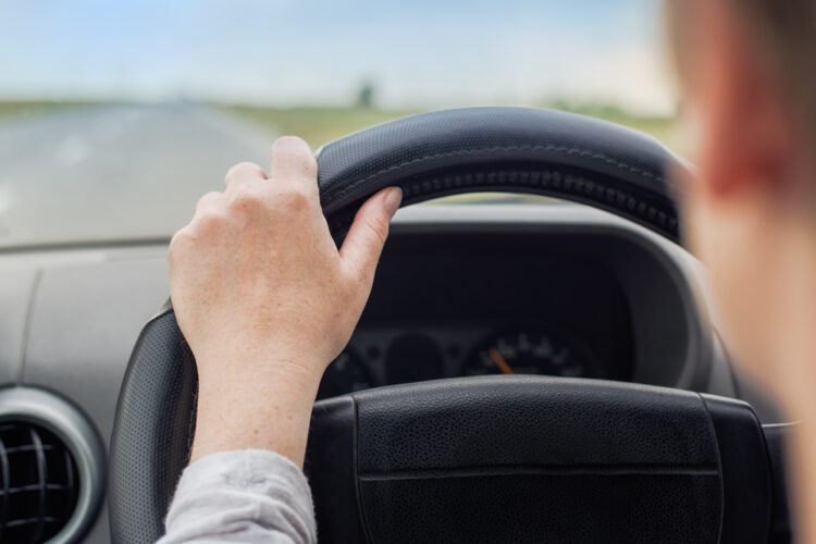 Person behind the wheel of an electric vehicle